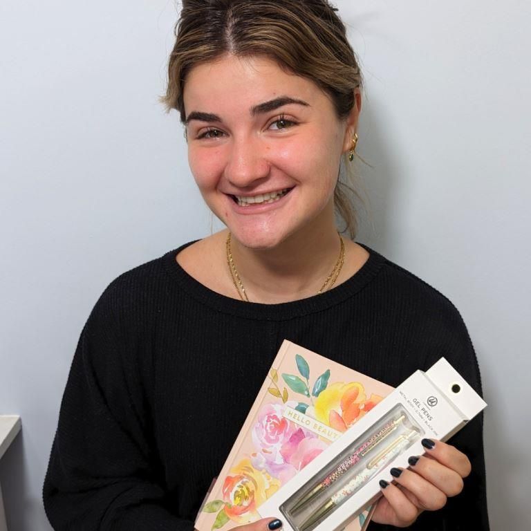 guest Izzy with a gift after treatment