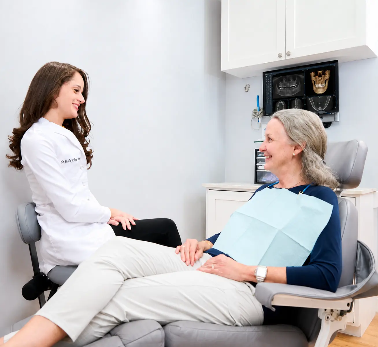 Dr. Yenile Pinto, DDS, reviewing whole-body dental care with a patient at Deering Dental in Palmetto Bay