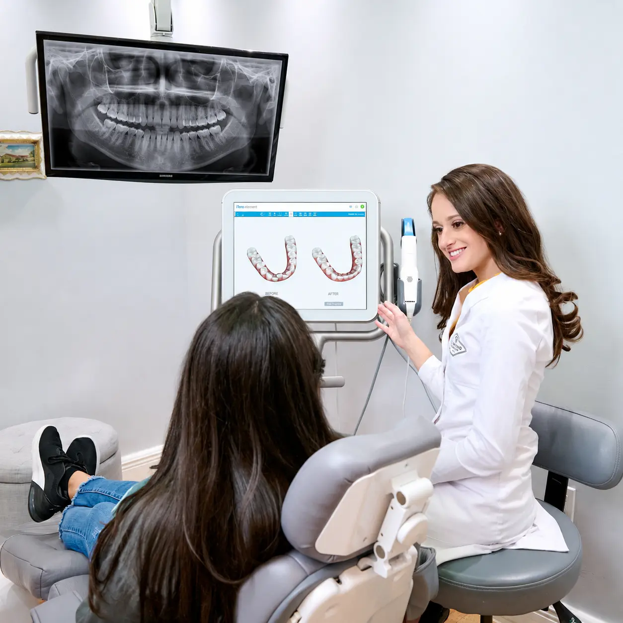 Dr. Yenile Pinto reviewing a patient's jaw imaging and bite scan at Deering Dental in Palmetto Bay