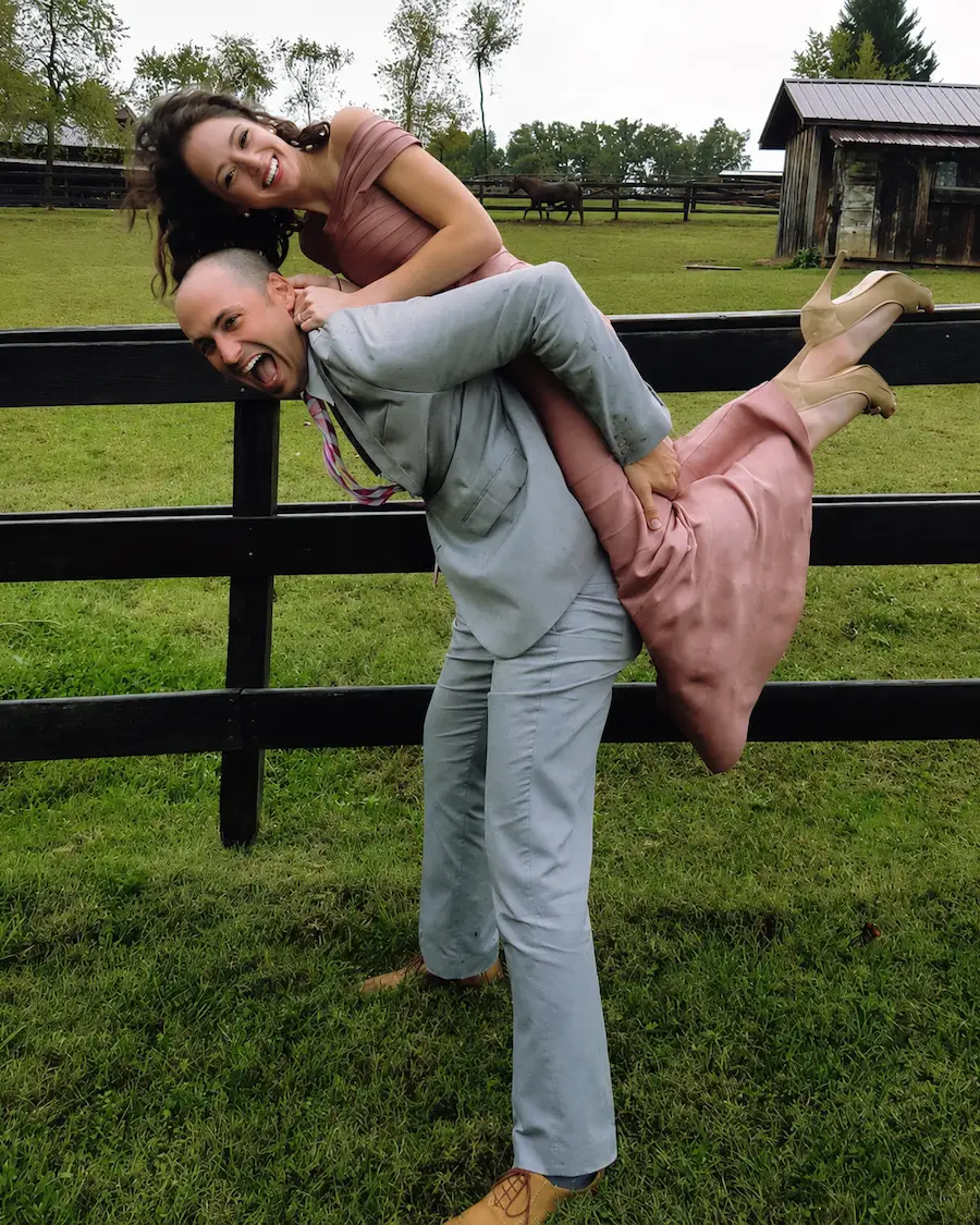Dr. Yenile Pinto and her husband Peter laughing together outdoors