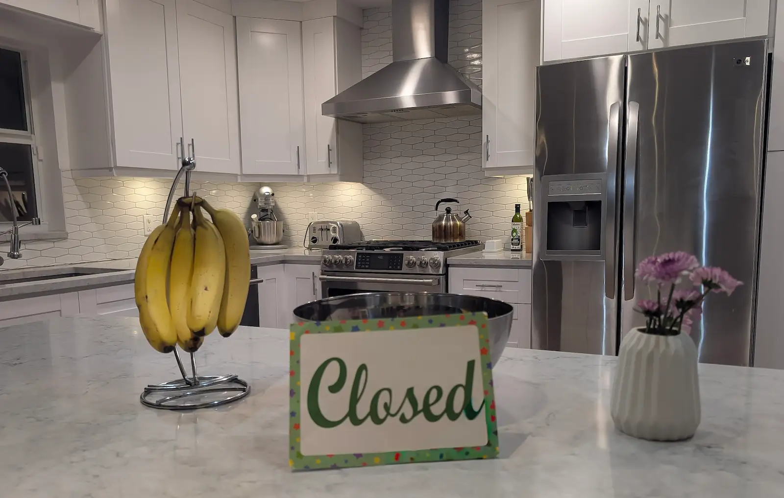 A hand-lettered Kitchen Closed sign the children made, taped up in the family kitchen.